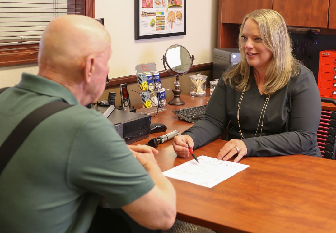 person-showing-a-patient-a-contract woman showing older patient a contract