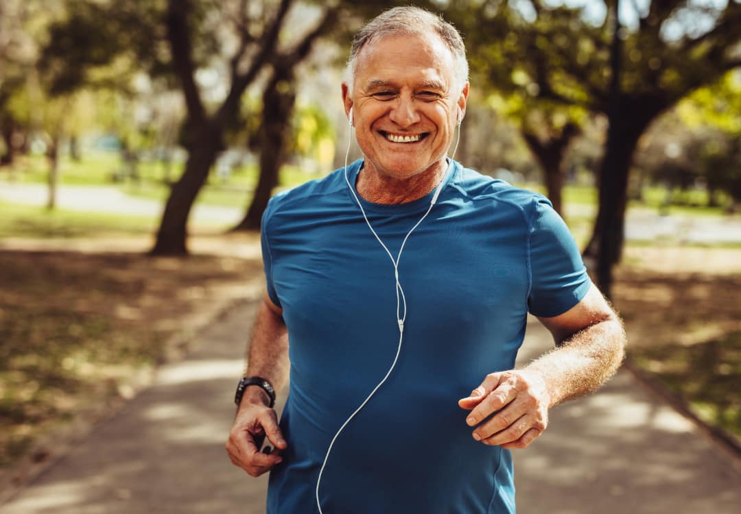 older-man-working-out-and-smiling older man smiling and going for a run