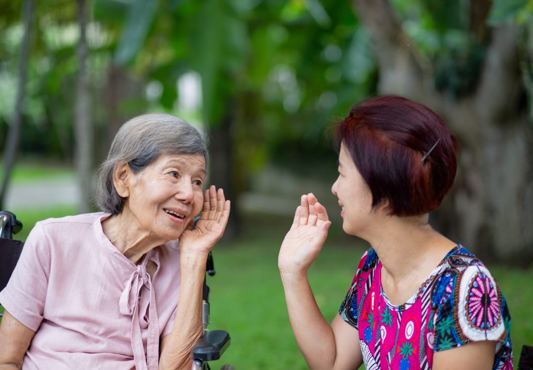 two-women-talking-and-having-difficulty-hearing two women talking and having difficulty hearing